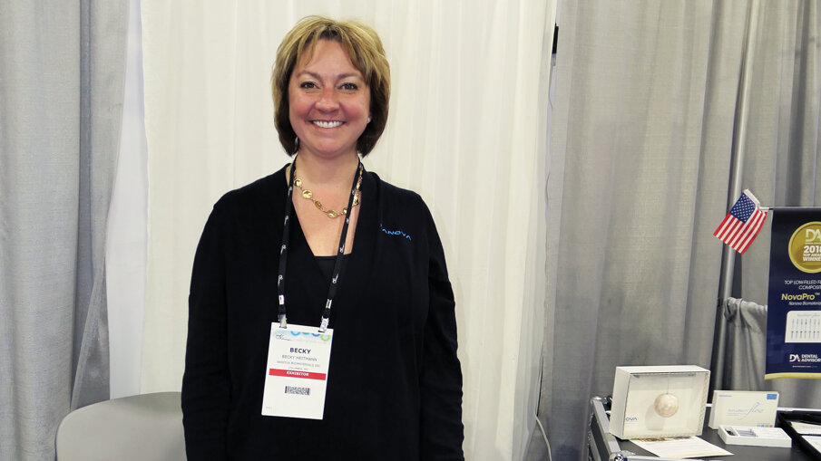 Becky Heitmann at the Nanova Biomaterials booth is happy to tell you all about the flowable and universal composites the company offers, among other products.