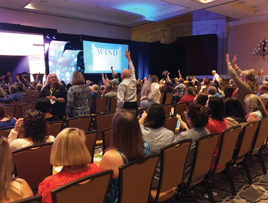 Attendees show off their excitement during Thursday morning’s opening session, featuring body language expert Traci Brown.