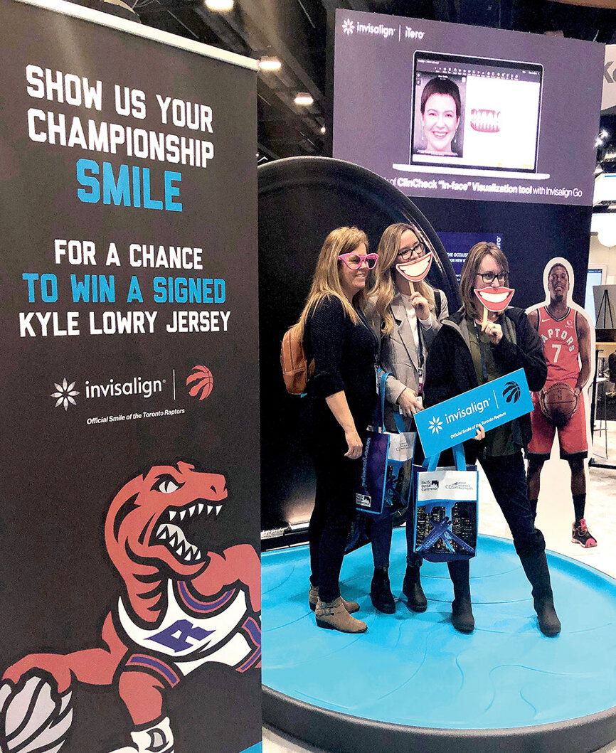 Sports fans pose for social meeting photos in the Invisalign iTero photo booth and enter for a chance to win a signed jersey from Kyle Lowry of the Toronto Raptors.