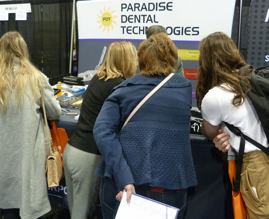 Not visible, Ross Beaudette, in the Paradise Dental Technologies (PDT) booth, helps attendees interested in the Montana-based company’s extensive line of instruments.