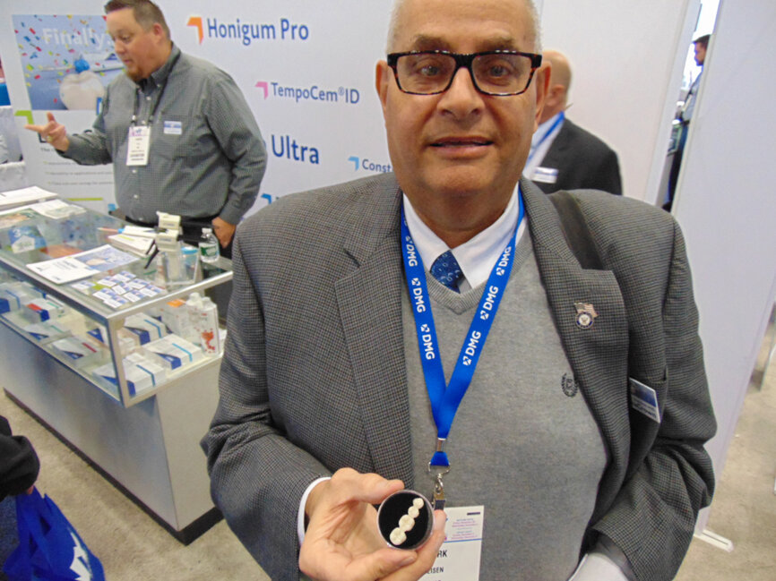 Mark Eisen of DMG holds a sample of the company’s new LuxaCrown, a semi-permanent crown and bridge material that is designed for easy use in one chairside session. (Photo: Fred Michmershuizen/DTA)