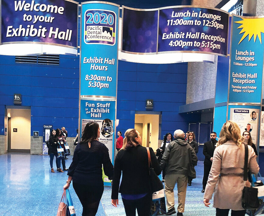 Attendees enter the Pacific Dental Conference exhibit hall on opening day.
