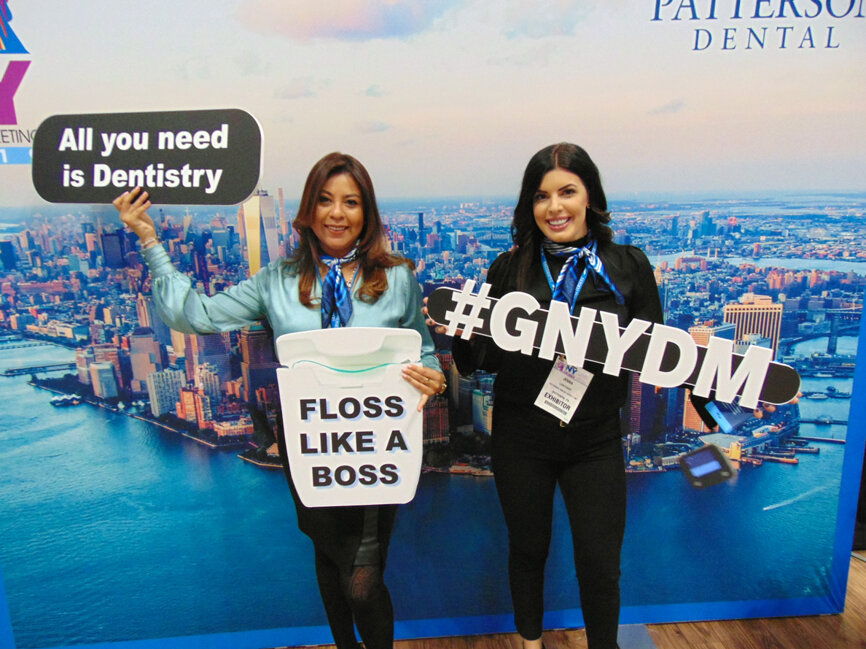 Regina Hutchins, left, and Jenna Lowthert of Patterson Dental Supply invite you to ‘recharge with Patterson’ on the exhibit hall floor. You can also take a selfie, and you can use the hashtags #GNYDM and #pattersondental for even more attention on social media. (Photo: Fred Michmershuizen/DTA)