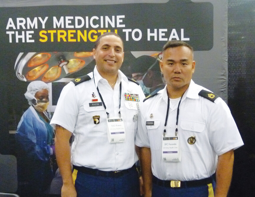 SSG Rivera and SFC Foronda stand at attention, ready to provide attendees the latest information on serving in the U.S. Army medicine team. (Photo: Sierra Rendon, DTA)