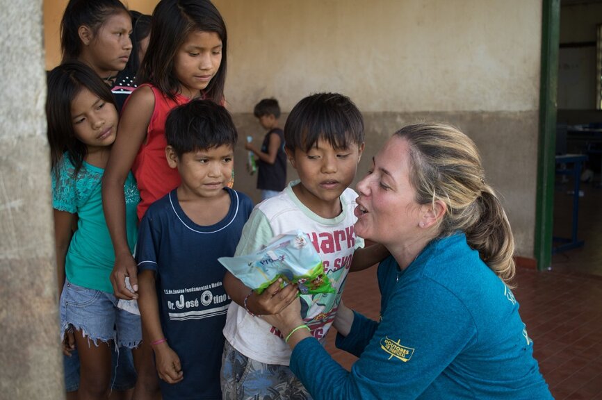 Fabiana Schleder Ruiz, Global Marketing Manager at Dentsply Sirona, distributing tooth cleaning kits to the indigenous people. (Photograph: Dentsply Sirona)