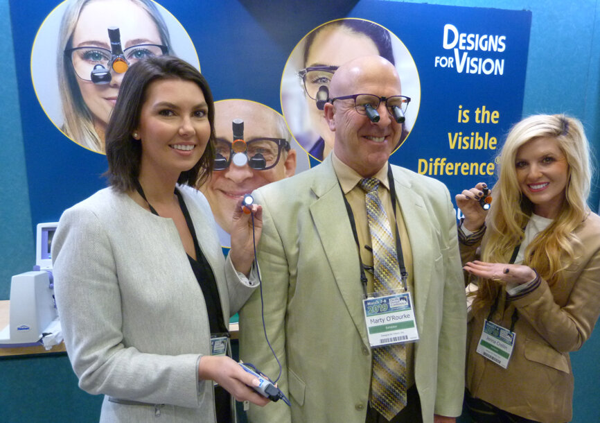 Erin Halvorson with the HDi Micro headlight, Marty O’Rourke with the Micro 4.5 EF loupes and Jenna Crellin with the WireLess HDi micro headlight in the Designs For Vision booth. (Photo: Robert Selleck/Dental Tribune)
