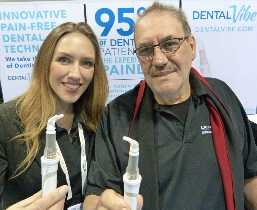 From left, displaying the innovative DentalVibe device for painless anesthetic injections, are Katie Smith and Vito Verzura.