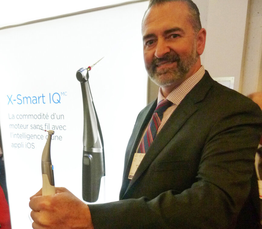 Nathan Roy displays the X-Smart IQ handpiece in the endo area of the sprawling Dentsply Sirona booth.