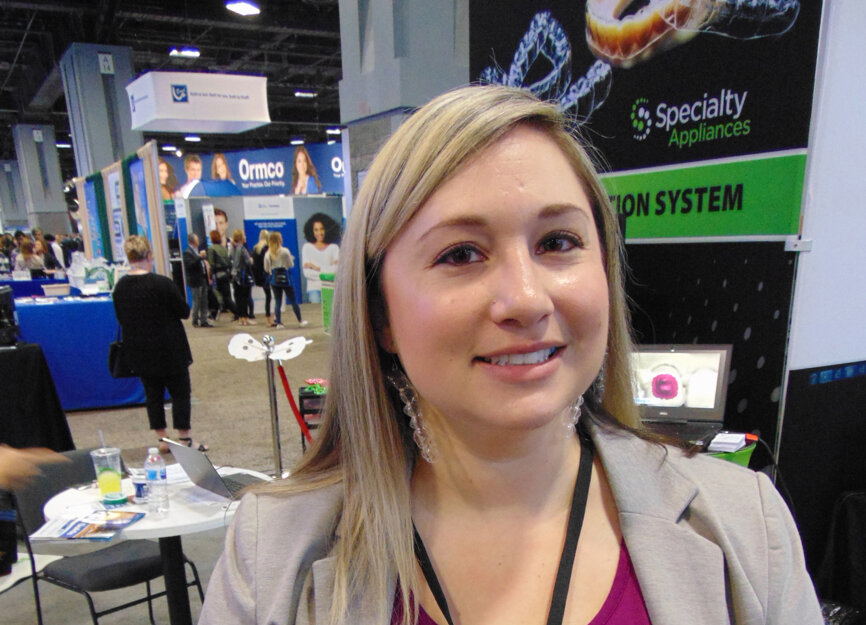 Erica McKinny of Specialty Appliances shows off some earrings made of clear aligners.