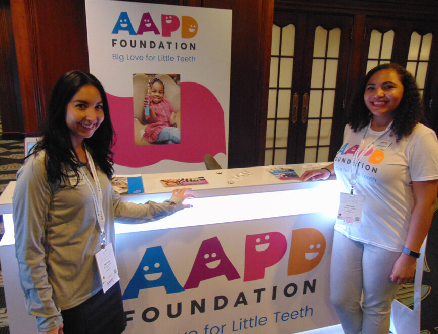 Representing the AAPD Foundation are Michelle Hidalgo, left, development and marketing manager, and Jasmine Williams, grants & programs assistant. (Photo by Fred Michmershuizen/Dental Tribune America)
