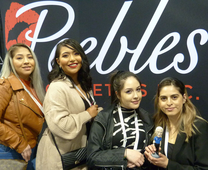 From left, in the Peebles Prosthetics booth, from Salud Family Health in Commerce City, Colo., are Perla Puentes, Mariela Santos-Castanon, Camilla Tavares and Maria Chavez (holding the bobble head of Peebles founder Rick Peebles). Peebles Prosthetics has been serving Denver area dental practices for 35 years and exhibiting at The RMDC for 15 years.