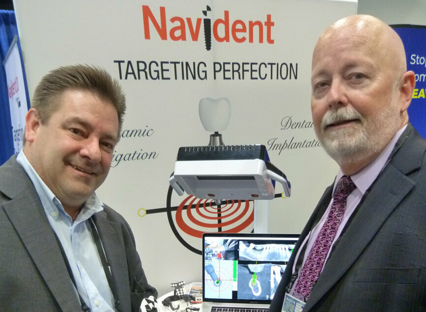 Mike Freeman and Darrell Cook demonstrate the high-tech but user-friendly ‘Trace-and-Place’ Navident system from ClaroNav. (Photo: Robert Selleck/Dental Tribune)