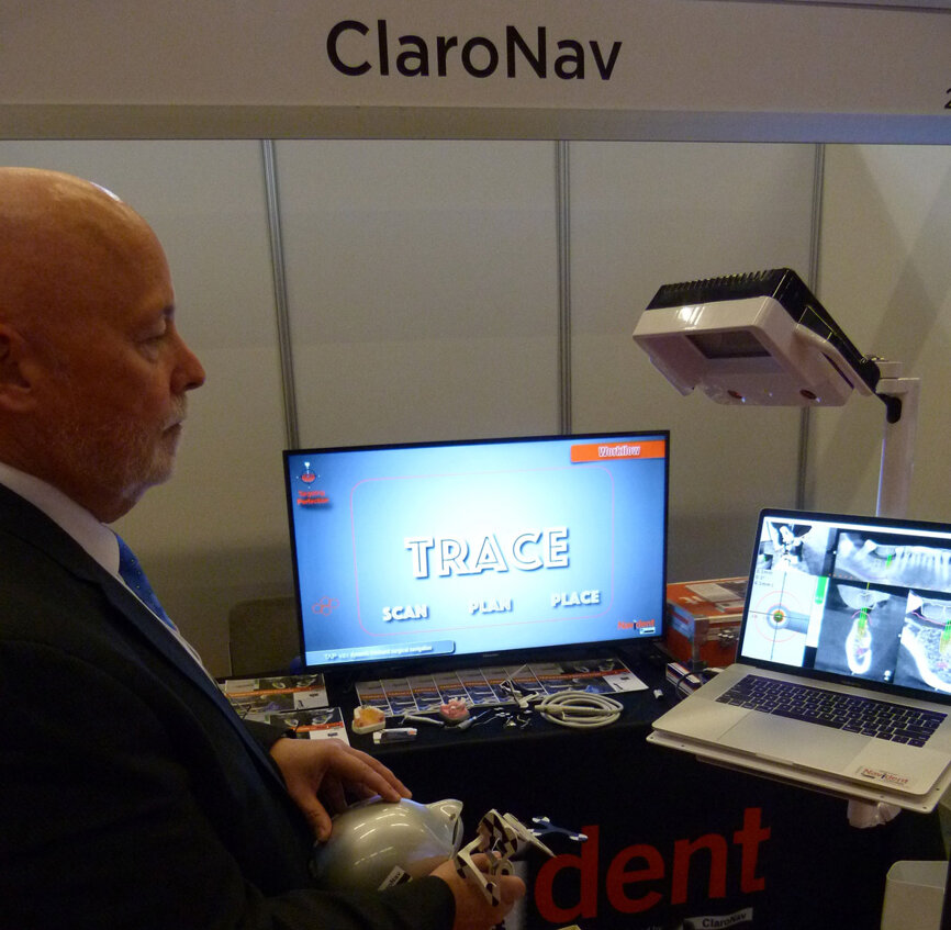 Darrell Cook demonstrates the Navident ‘Trace and Place’ guided surgical system in the ClaroNav booth.