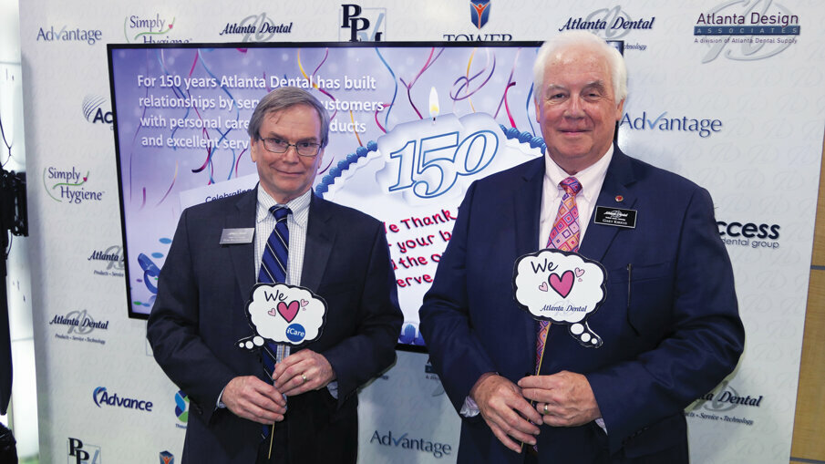 Tom Richardson, president of Atlanta Dental, left, and Gary Kirkus help celebrate the company’s 150 years of service. 