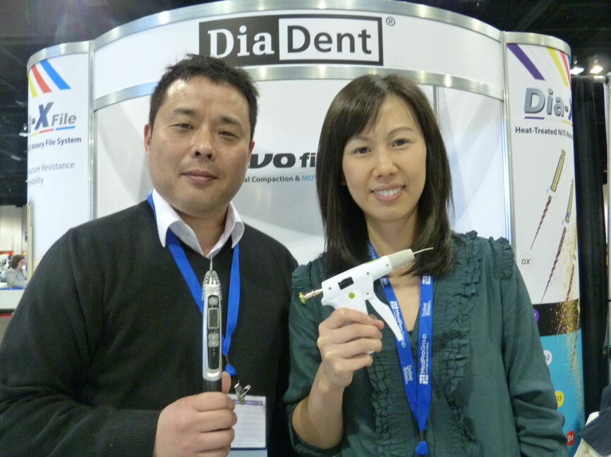 Steve Kim (holding an EvoFill) and Katie Liu (with a Duo-Gun) in the DiaDent booth.