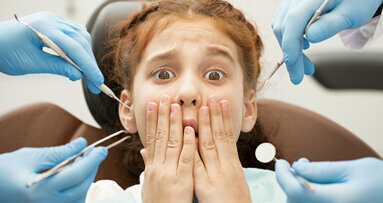 How can the dental team help reduce patient anxiety?