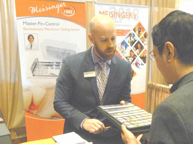 James Scyoc helps Dr. Chan Teng Ye of Malaysia in the Meisinger booth.