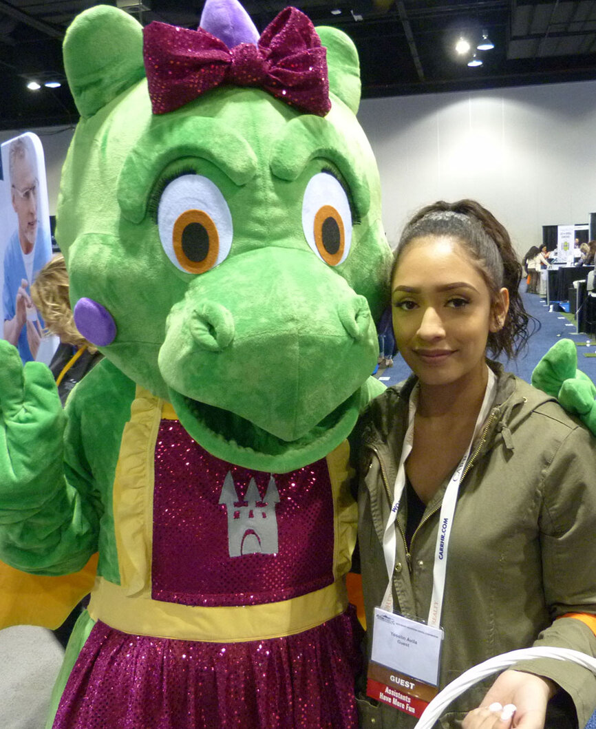 From left, Daisy The Dragon and Dental Assistant Yoselin Avila, wandered the Expo Hall aisles handing out Children’s Dentistry stickers to promote the pediatric dentistry practice in Westminster, Colo.