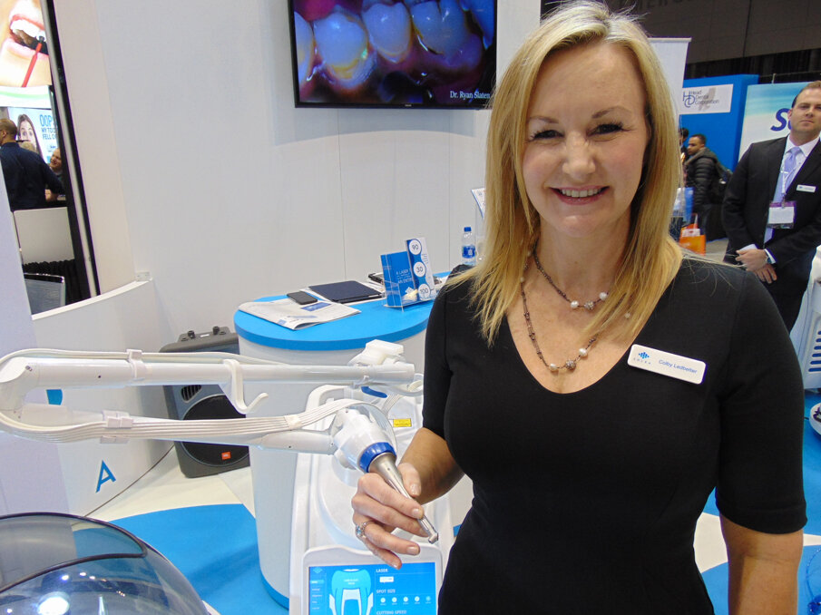 Colby Ledbetter of Convergent Dental holds the Solea laser.  She’s wearing a diamond and blue topaz ring in 14-karat white gold, which was the grand prize in the raffle at Oral Health America’s Gala & Benefit. (Photo: Fred Michmershuizen/Dental Tribune America)