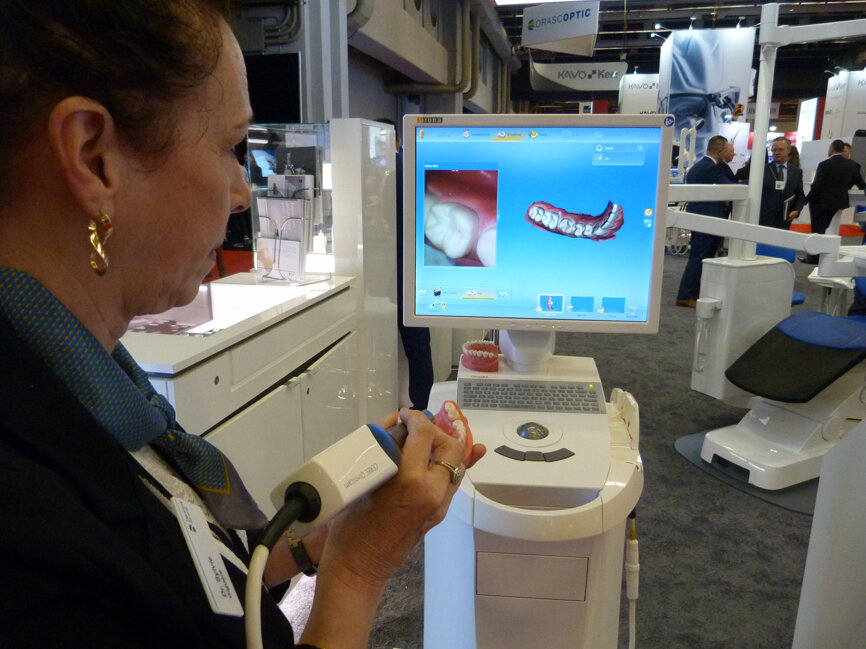 Sylvie Giguere demonstrates how easy it is to scan and mill with one of the display setups in the Dentsply Sirona booth.
