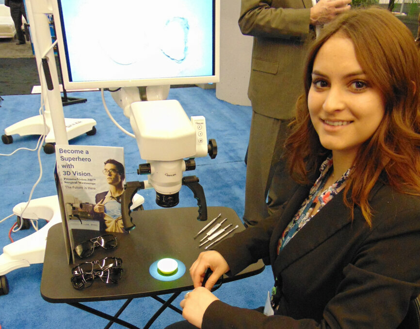 Kelly Payan of Seiler shows off the company’s Promise Vision 3D surgical microscope. (Photo: Fred Michmershuizen/Dental Tribune America)