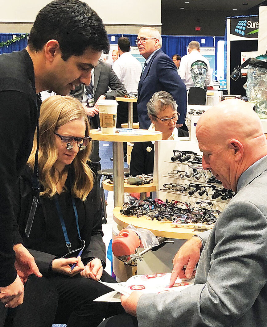 Marty O’Rourke of Designs for Vision helps an attendee pick out the best loupes to fit her individual needs.