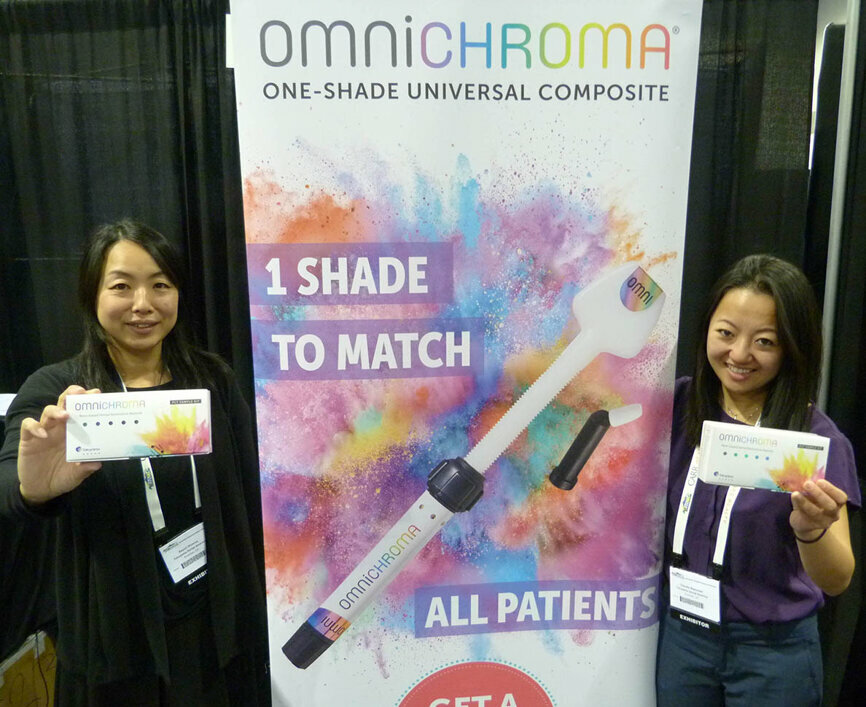 From left, in the Tokuyma Dental America booth, Sayuri Viveros and Anna Mai are offering boxes of Omnichroma with a buy-one-get-one-free special. The product is the world’s first dental composite that matches every tooth with a single composite shade.